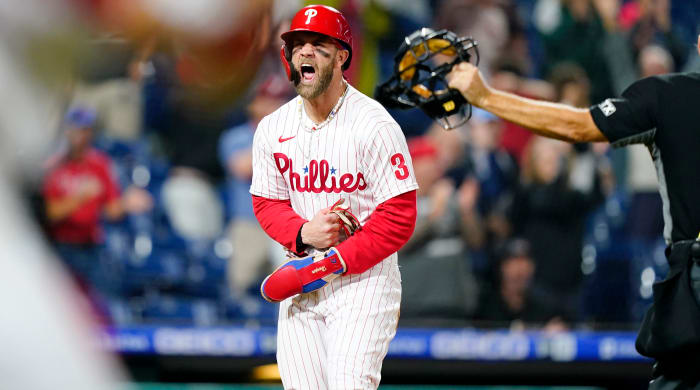 Philadelphia Phillies’ Bryce Harper celebrates after scoring the game-winning run on an RBI-single by Jean Segura during the ninth inning of a baseball game, Tuesday, Sept. 6, 2022, in Philadelphia.